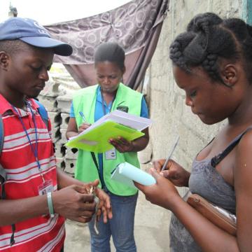 Frantz (left) working with SOIL's EkoLakay in Cap-Haïtien, 2015. Photo by Vic Hinterlang.