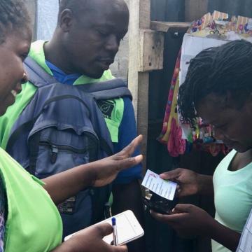 EkoLakay team members with customer