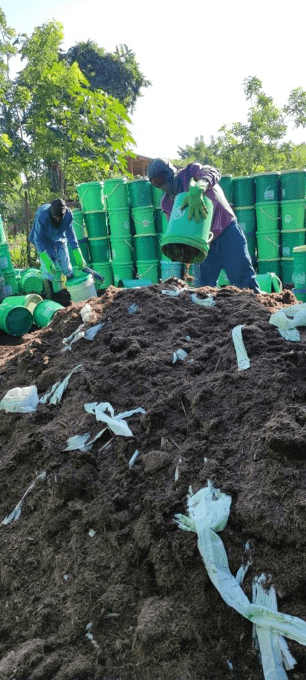 SOIL’s waste treatment team emptying containers