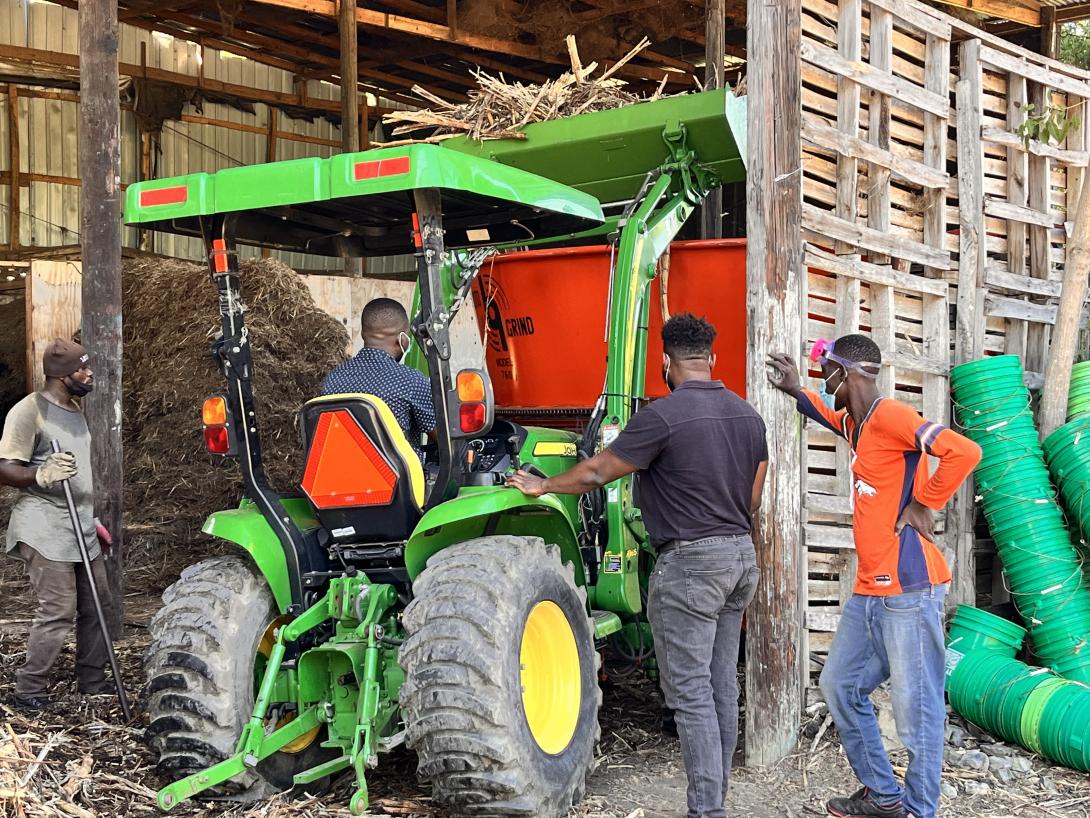 Loading grinder with green tractor